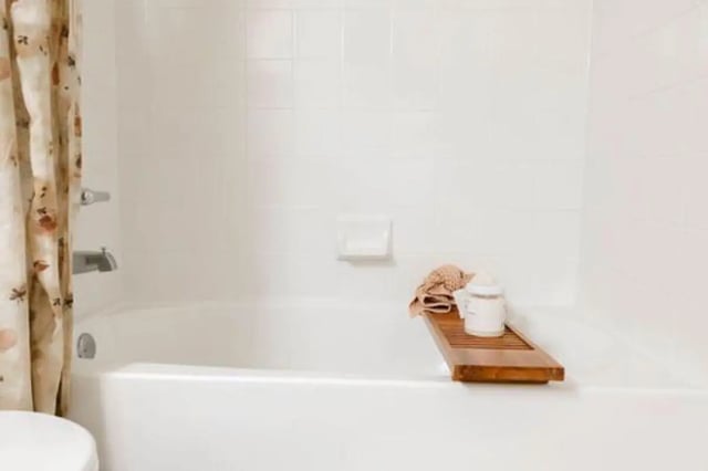 Bath with soap dispenser tray and towel bathroom at The Lodge Apartments in San Marcos Student Accommodation