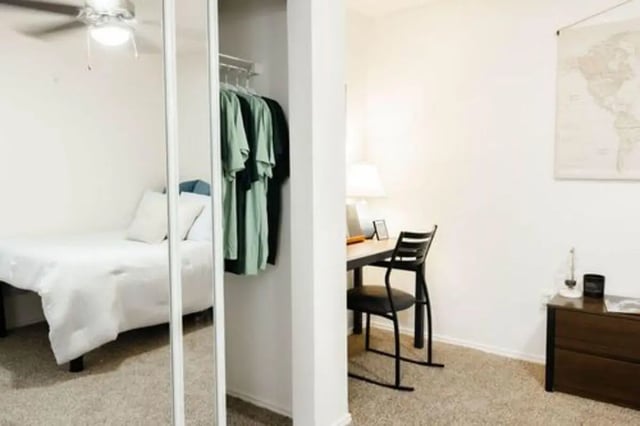 Bed desk chairs clothes hanging bed bedroom study area at The Lodge Apartments in San Marcos Student Accommodation