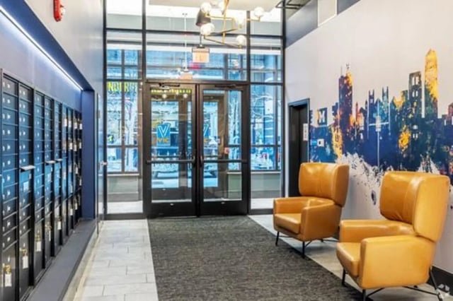 Mailboxes chairs and city mural lobby at Vic Village South in Ann Arbor Student Accommodation