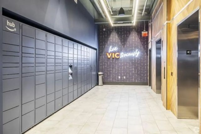 Package lockers and elevators in hallway interior at Vic Village South in Ann Arbor Student Accommodation