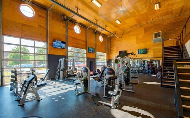 Gym equipment weights and machines gym area at Campus Court At Knollwood in Kalamazoo Student Accommodation