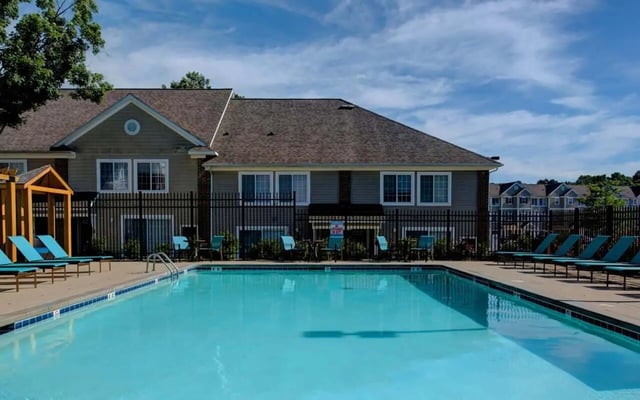 Pool loungers and tables exterior at Campus Court At Knollwood in Kalamazoo Student Accommodation
