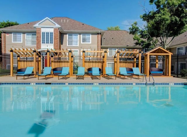 Pergolas lounge chairs and pool exterior at Campus Court At Knollwood in Kalamazoo Student Accommodation
