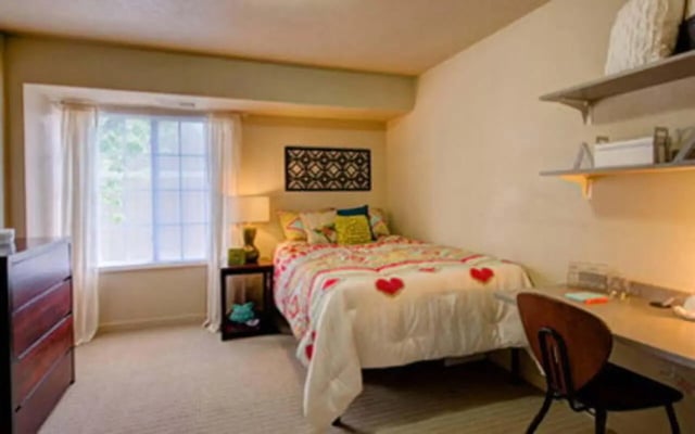 Bed dresser window desk chair bedroom at Campus Court At Knollwood in Kalamazoo Student Accommodation