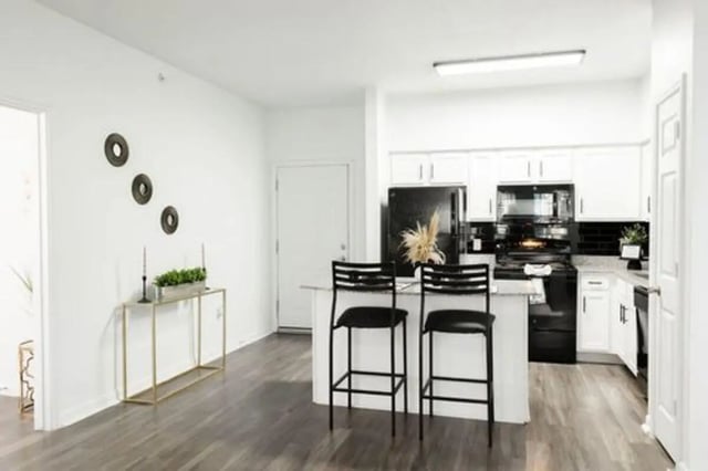 Kitchen island bar stools refrigerator and cabinets kitchen at Villagio Apartments in San Marcos Student Accommodation