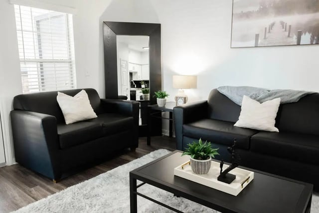 Black sofas and coffee table living room at Villagio Apartments in San Marcos Student Accommodation