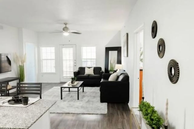 Black couches rug coffee table living room at Villagio Apartments in San Marcos Student Accommodation