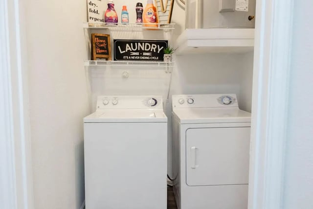 White washing machine and dryer laundry room at Villagio Apartments in San Marcos Student Accommodation