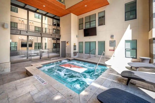 Hot tub with lounge chairs courtyard area at Villas on 26th in Austin Student Accommodation