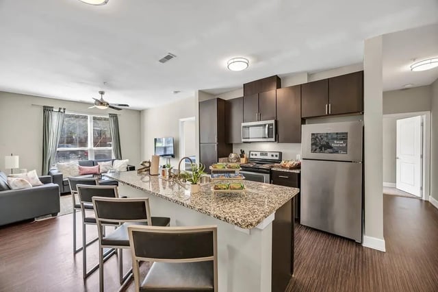 Kitchen island with seating and living area Living room kitchen at Park Place Waco in Waco Student Accommodation