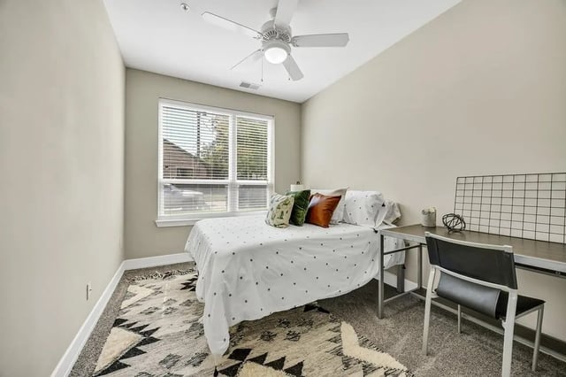 Bed desk chair and rug bedroom at Park Place Waco in Waco Student Accommodation