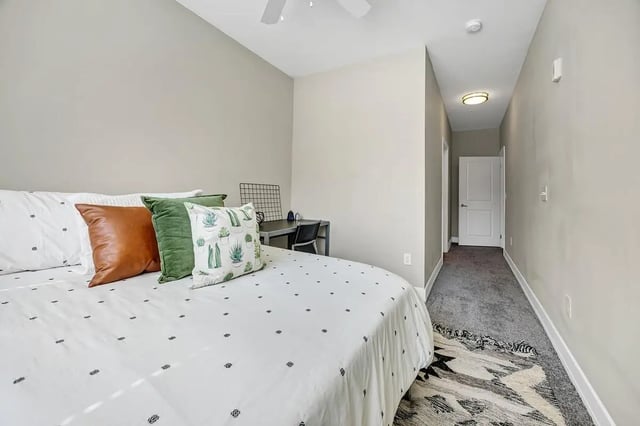 Bed desk pillows and rug bedroom at Park Place Waco in Waco Student Accommodation