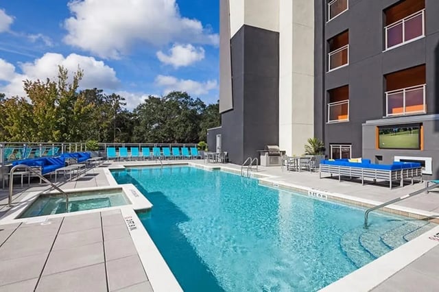 Pool with lounge chairs and hot tub Exterior at Social 28 in Gainesville Student Accommodation