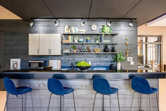Blue bar stools at counter with microwave and shelves kitchen at The Hills Northview Apartments in Harrisonburg Student Accommodation