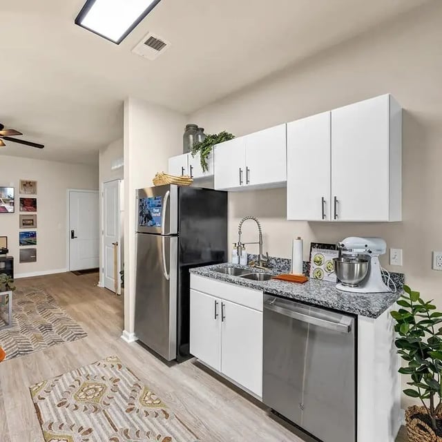 Kitchen with stainless steel appliances and white cabinets Kitchen at The Luxe on West Call in Tallahassee Student Accommodation