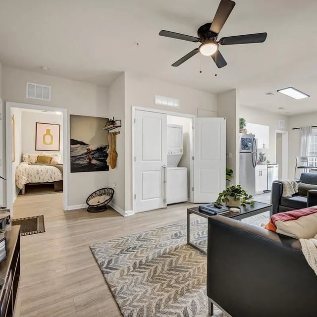 Bed bedroom laundry appliances living room kitchen exterior at The Luxe on West Call in Tallahassee Student Accommodation