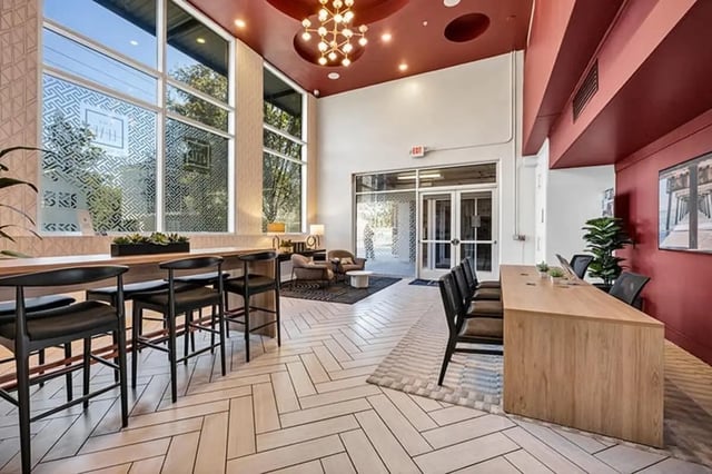 Bar seating and desks with chairs communal area at The Luxe on West Call in Tallahassee Student Accommodation