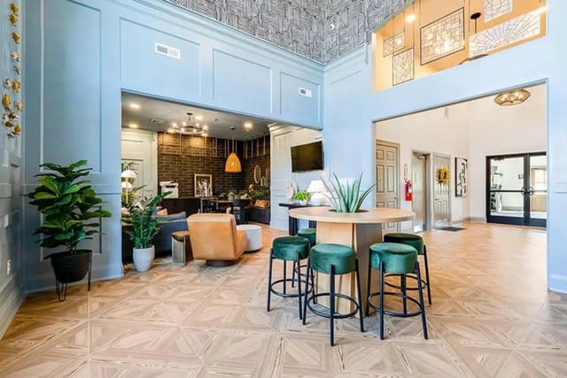 Lobby area with seating and plants living room at The Hills Southview Apartments in Harrisonburg Student Accommodation