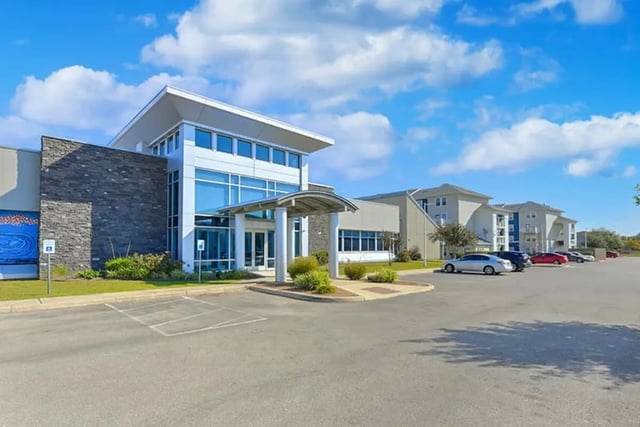 Modern building with parking lot exterior at The Avenue at San Marcos in San Marcos Student Accommodation