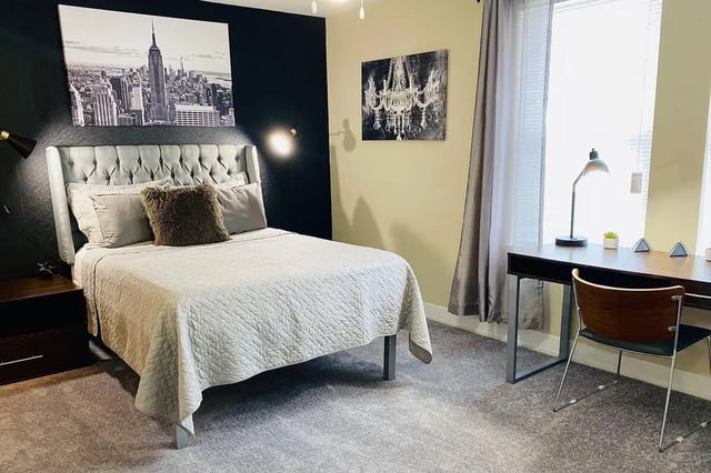 Tufted headboard bed desk and chair bedroom at The Avenue at San Marcos in San Marcos Student Accommodation