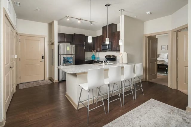 Kitchen island with white stools and interior view at The Hayward Student Living in Eugene Student Accommodation