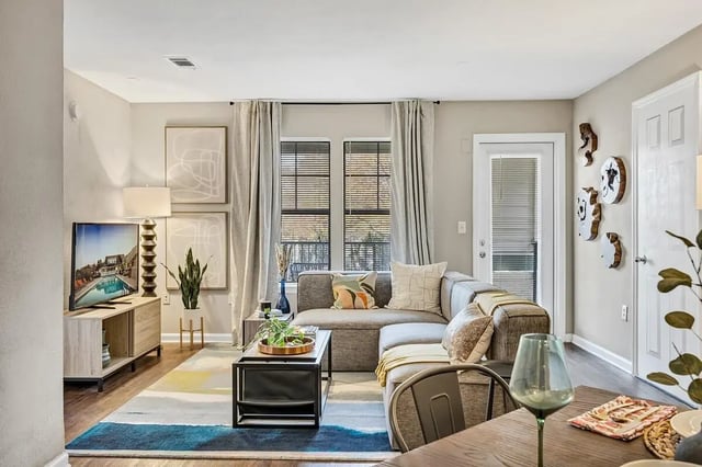 Gray sectional couch with coffee table living room at The Wilde Raleigh Apartments in Raleigh Student Accommodation