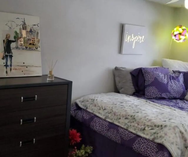 Painting dresser and purple floral bedding bedroom at Capri Eugene Apartments in Eugene Student Accommodation