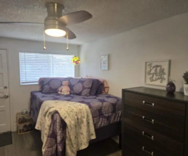 Bed with purple bedding dresser and ceiling fan bedroom at Capri Eugene Apartments in Eugene Student Accommodation