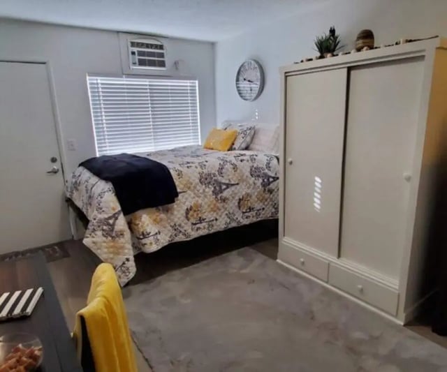Bed wardrobe clock and air conditioner bedroom at Capri Eugene Apartments in Eugene Student Accommodation