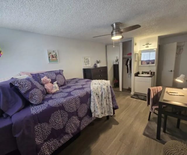 Purple patterned bed white sink desk bedroom at Capri Eugene Apartments in Eugene Student Accommodation