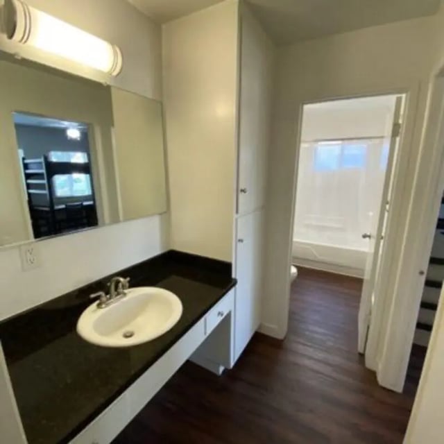 Sink countertop cabinet with reflection of bunk beds Bedroom bathroom at Capri at Isla Vista Apartments in Isla Vista Student Accommodation