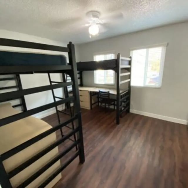 Two bunk beds with desks and chairs bedroom at Capri at Isla Vista Apartments in Isla Vista Student Accommodation