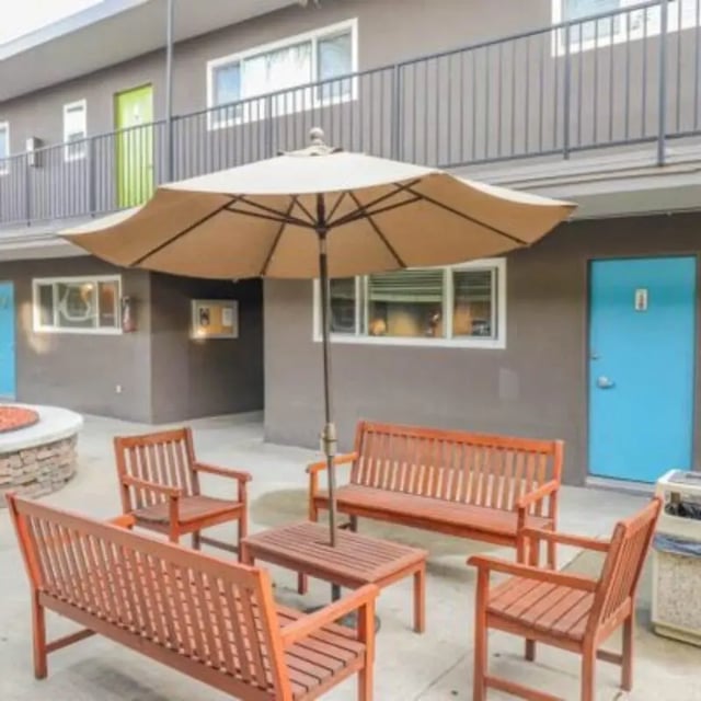 Outdoor seating area with umbrella and benches Exterior at Capri at Isla Vista Apartments in Isla Vista Student Accommodation