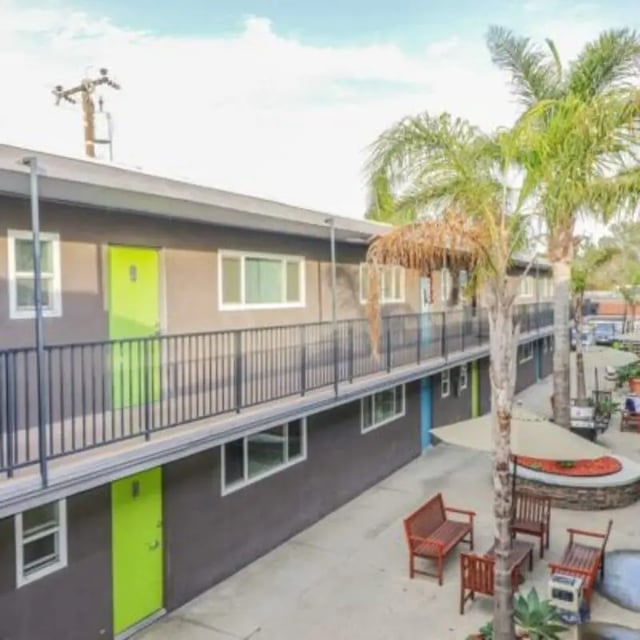 Apartment building with lime green doors and balconies exterior at Capri at Isla Vista Apartments in Isla Vista Student Accommodation