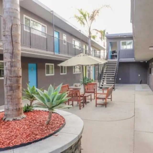 Courtyard with seating umbrella and plants exterior at Capri at Isla Vista Apartments in Isla Vista Student Accommodation