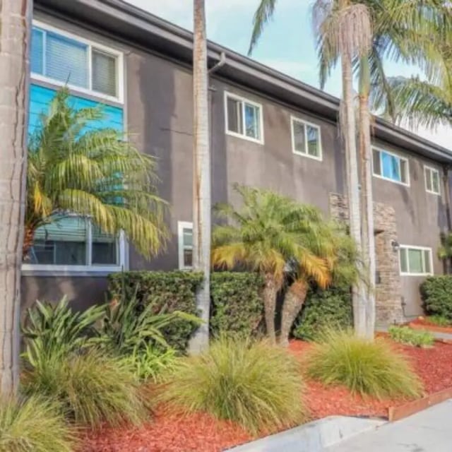 Apartment building with tropical plants exterior at Capri at Isla Vista Apartments in Isla Vista Student Accommodation