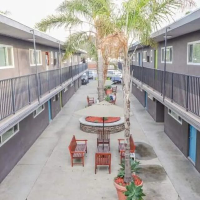 Courtyard with benches tables and palm trees exterior at Capri at Isla Vista Apartments in Isla Vista Student Accommodation