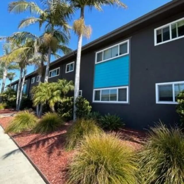 Modern apartment building with palm trees exterior at Capri at Isla Vista Apartments in Isla Vista Student Accommodation