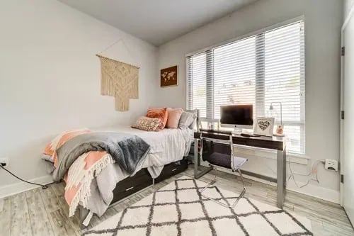 Bed desk computer macrame wall hanging bedroom at 1301 Hillsborough Apartments in Raleigh Student Accommodation