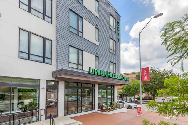 Modern building with windows and signage exterior at 1301 Hillsborough Apartments in Raleigh Student Accommodation