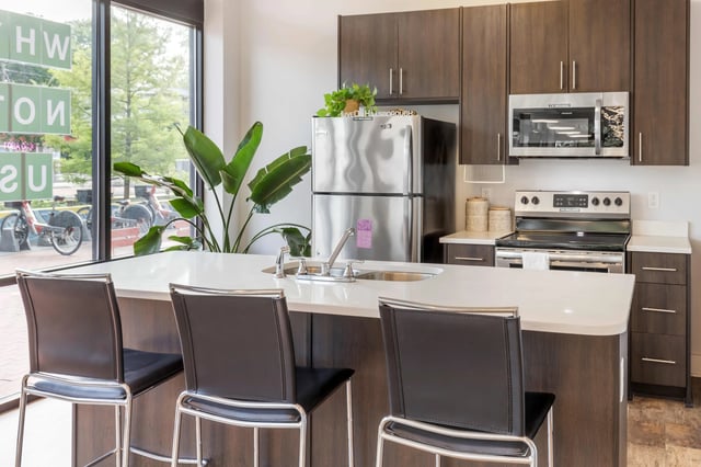 Modern kitchen with island and bar stools kitchen at 1301 Hillsborough Apartments in Raleigh Student Accommodation