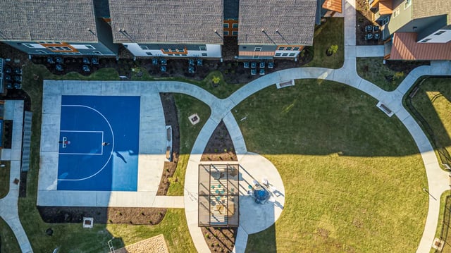 Basketball court grass and outdoor seating area exterior at Aspen Heights Fayetteville in Fayetteville Student Accommodation