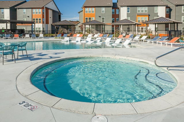 Circular jacuzzi and lounge chairs exterior pool area at Aspen Heights Fayetteville in Fayetteville Student Accommodation