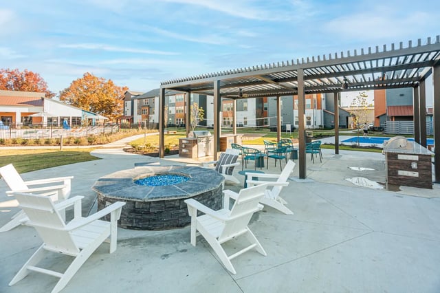 Adirondack chairs fire pit grill patio area exterior at Aspen Heights Fayetteville in Fayetteville Student Accommodation