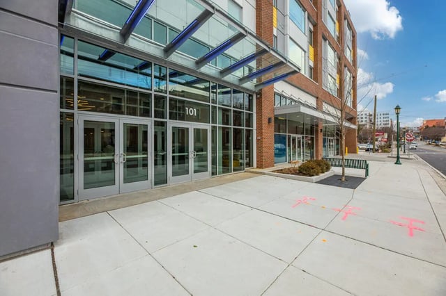 Glass doors building entrance with numbered sign exterior at Aspen Heights Towson in Towson Student Accommodation