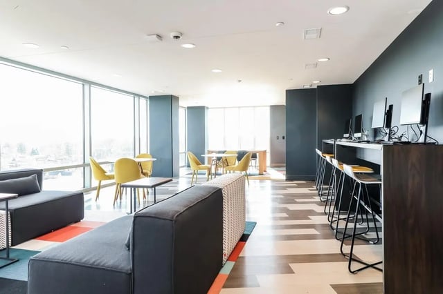 Sofas tables chairs and computers common area at Aspen Heights Towson in Towson Student Accommodation