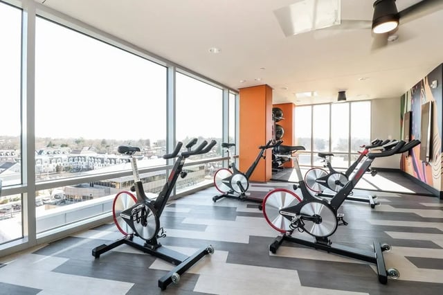Spin bikes with large windows workout room at Aspen Heights Towson in Towson Student Accommodation