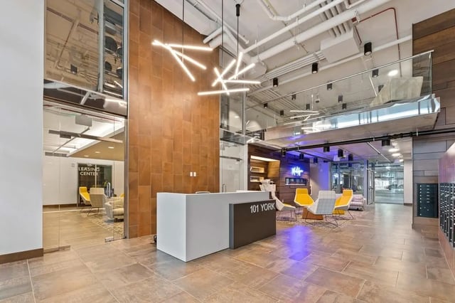 Reception desk with chairs and seating area lobby at Aspen Heights Towson in Towson Student Accommodation