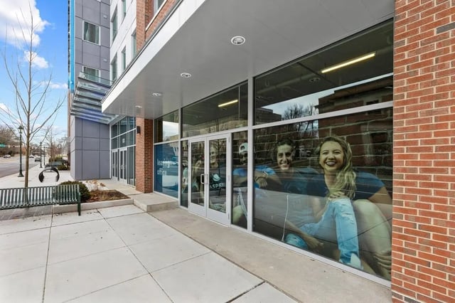 Leasing office windows with happy students exterior at Aspen Heights Towson in Towson Student Accommodation