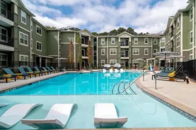 Apartment buildings surround a sparkling swimming pool exterior at 14 SixtyFive in Kennesaw Student Accommodation